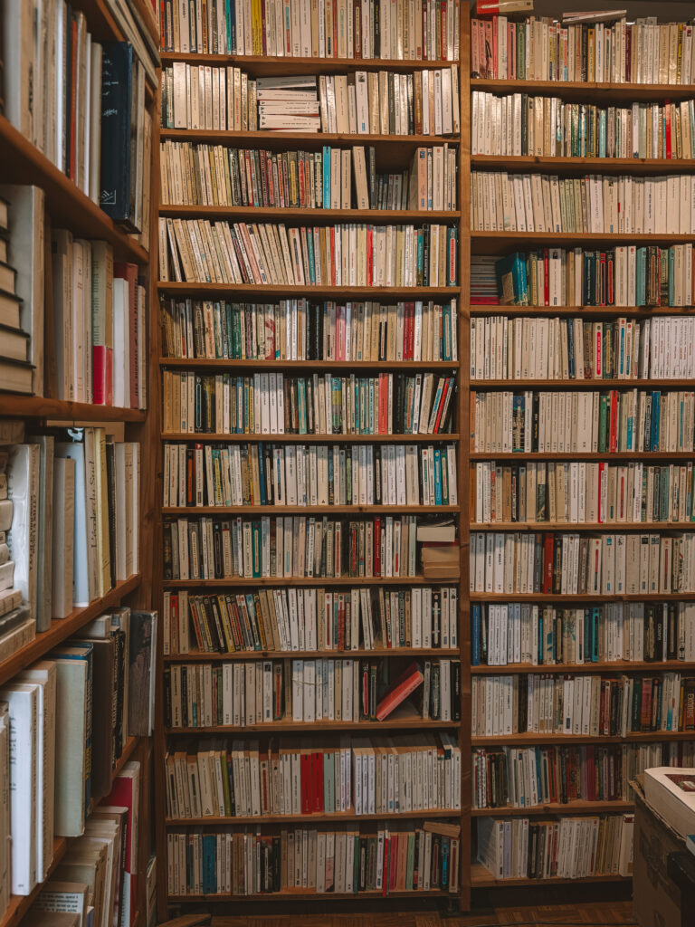 Second-hand bookshop in Caen France with books stacked floor to ceiling