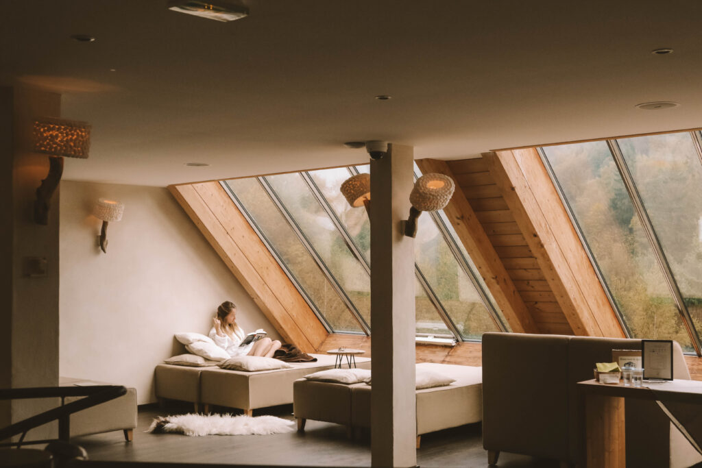 Reading a book while sitting by a window in a spa