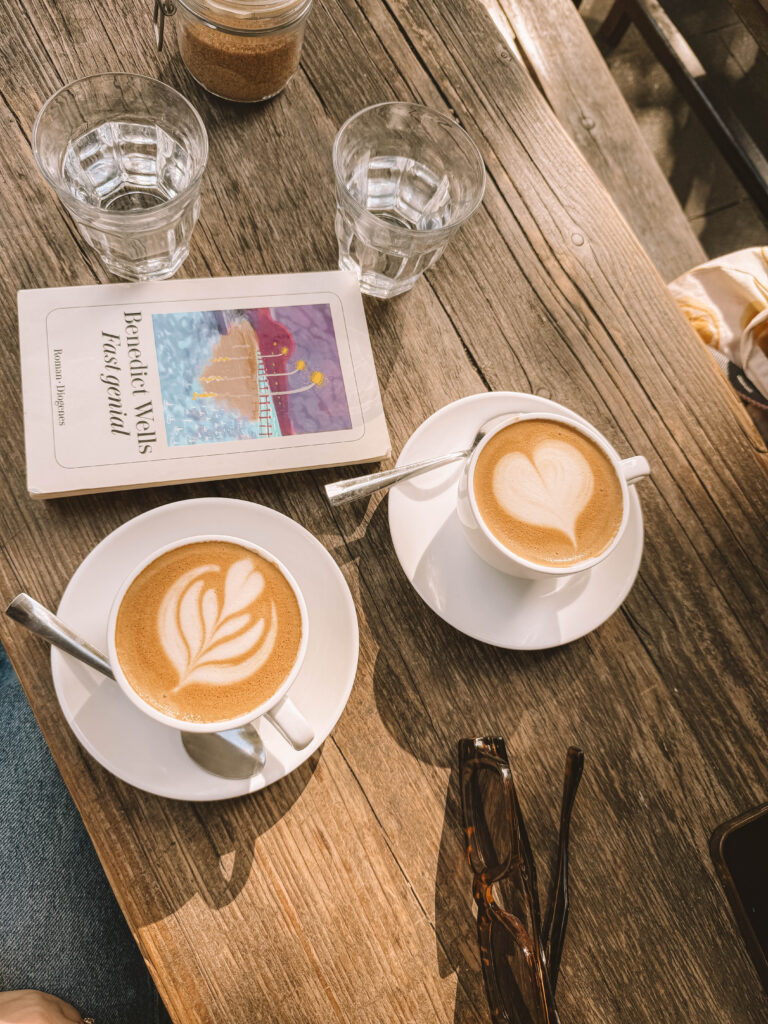 Reading a book with a cup of coffee nearby