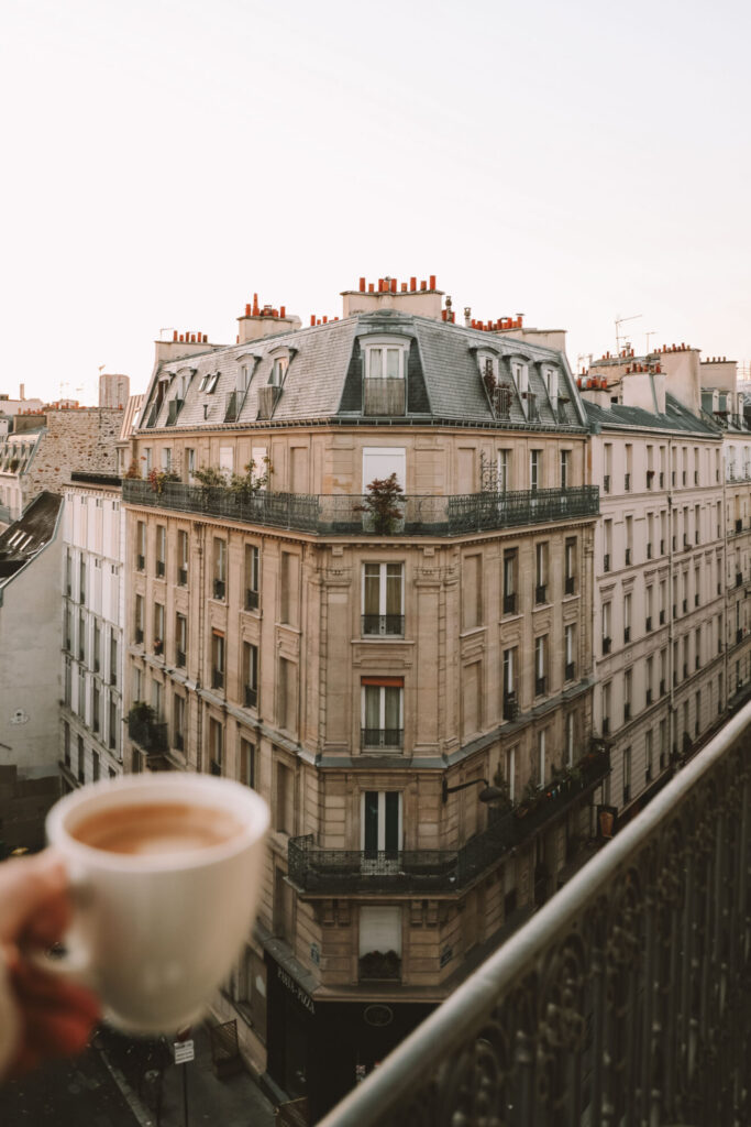 Paris at dusk with historic Haussmann buildings and a coffee