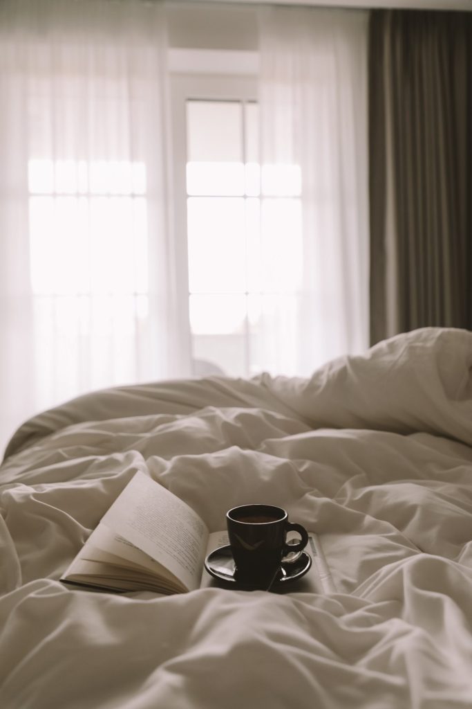 Book and coffee at a hotel breakfast, combining reading with a slow morning
