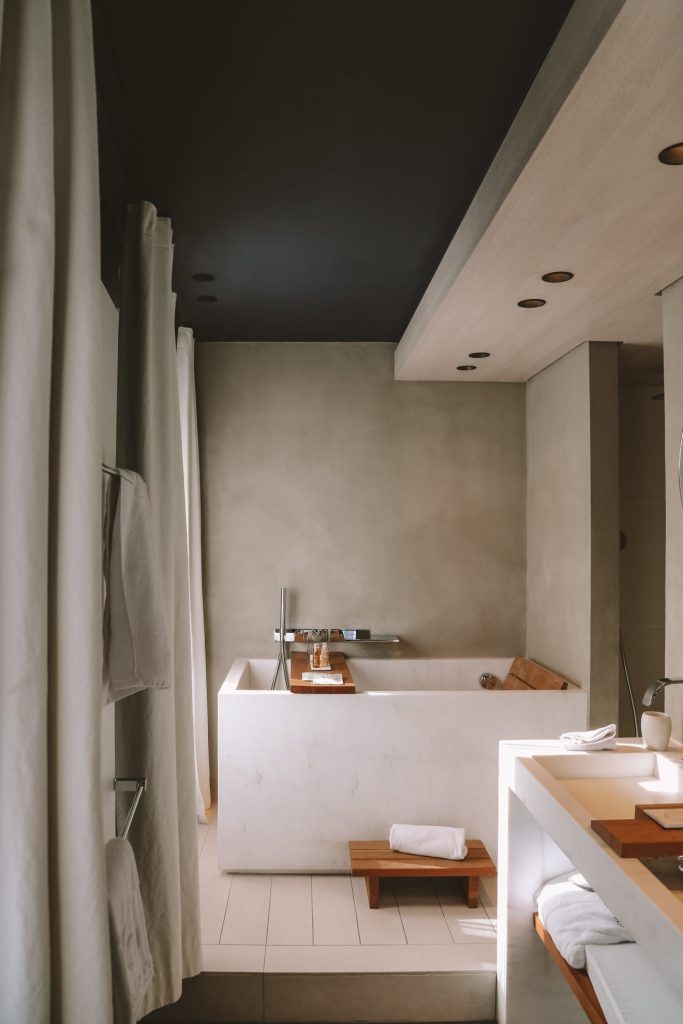 Elegant hotel bathroom with a freestanding bathtub, made for a quiet afternoon with a book