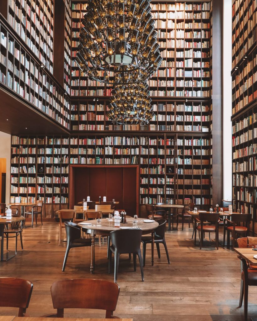 Beautiful hotel library with bookshelves and classic reading spaces